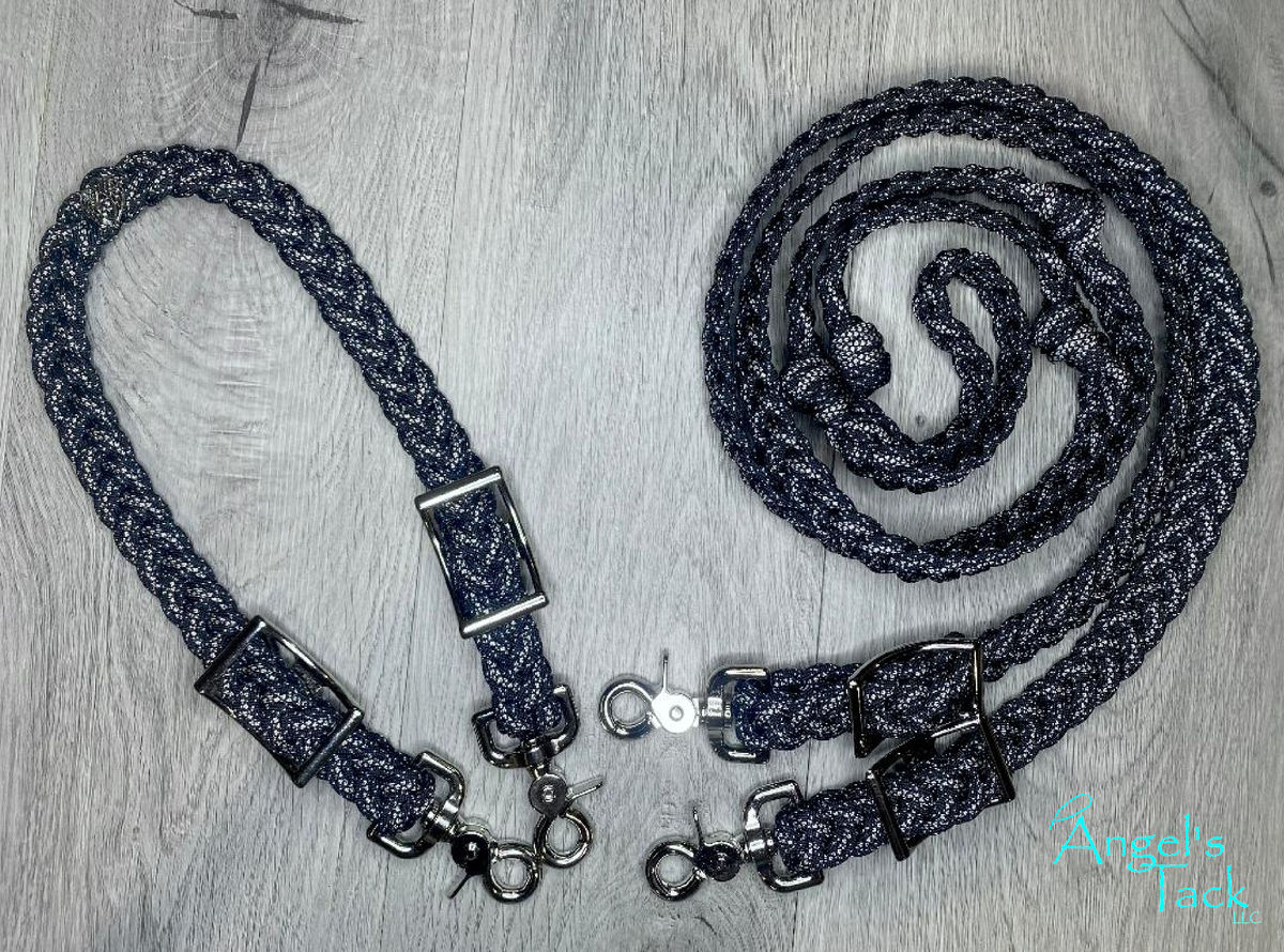A black diamond and sparkle patterned braided paracord barrel rein and wither strap set by Angel's Tack LLC. The wither strap is shown to the left and the reins are coiled on the right.