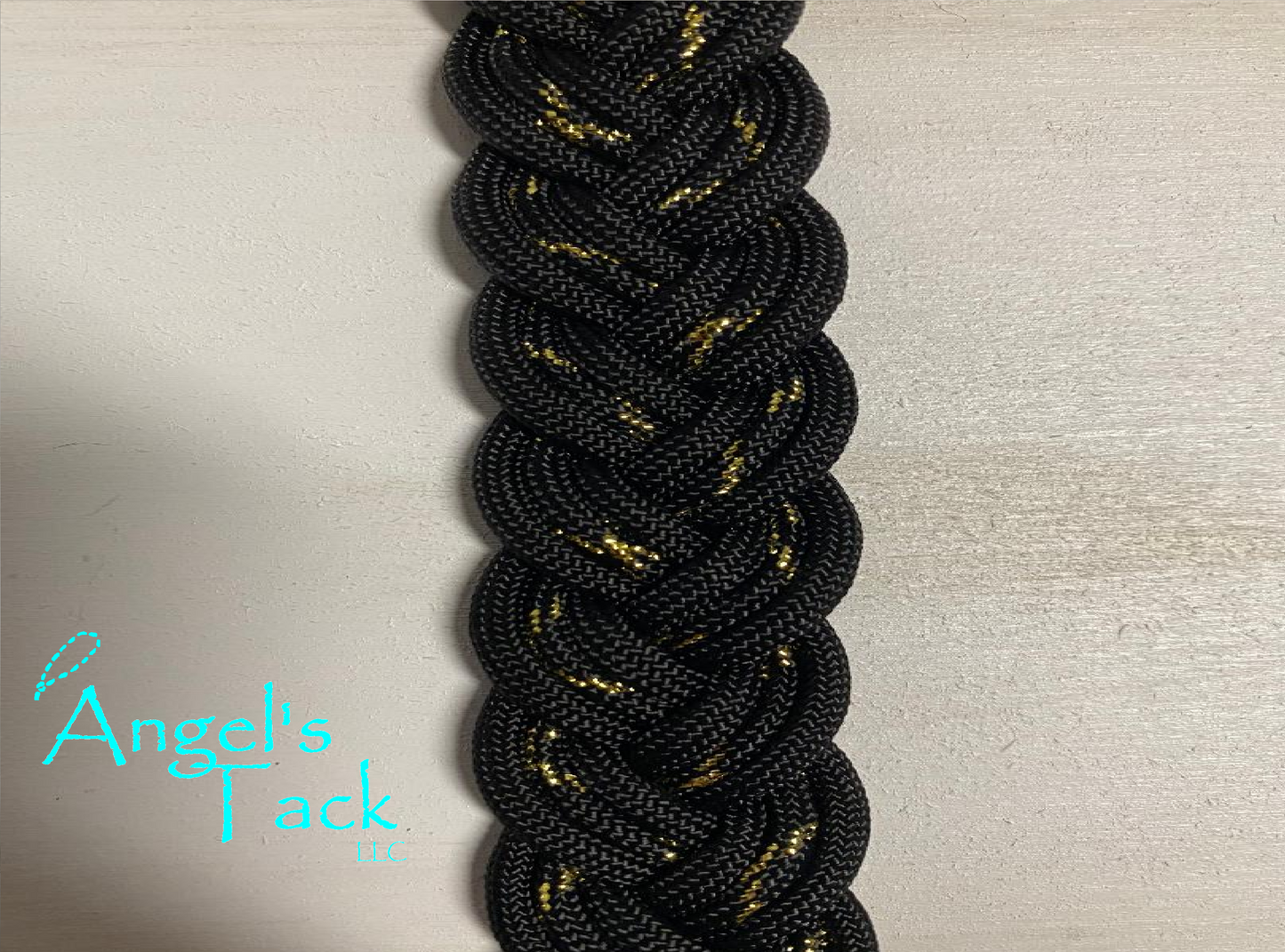 Black and metallic gold braided paracord barrel reins, close up
