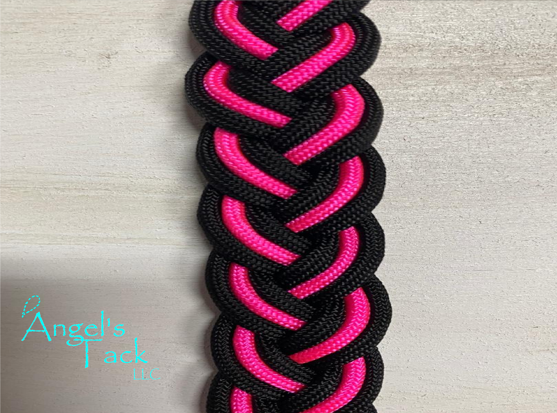 Hot pink and black barrel reins, close up