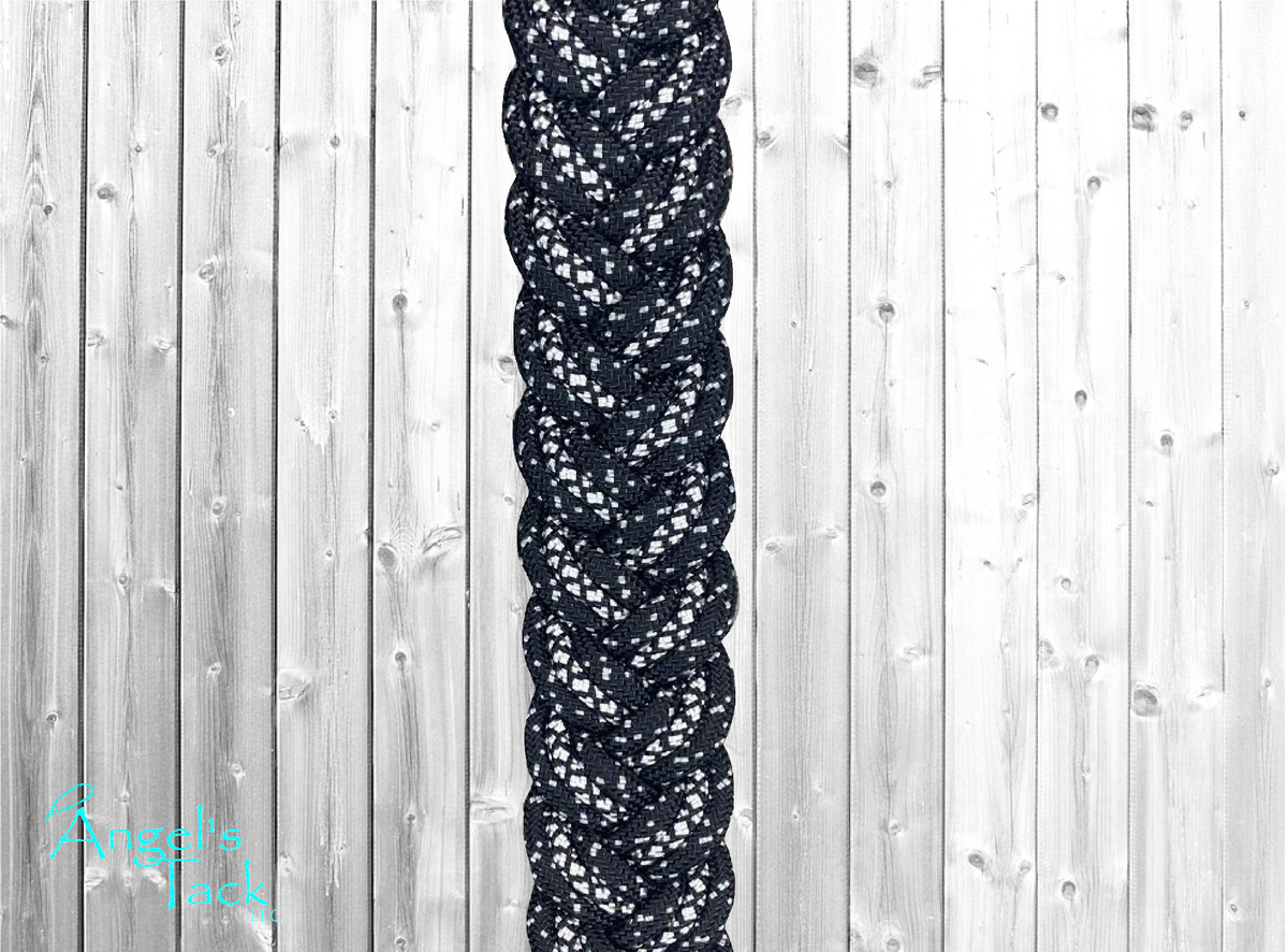 A close up of black diamond and sparkle patterned braided paracord barrel reins by Angel's Tack LLC.
