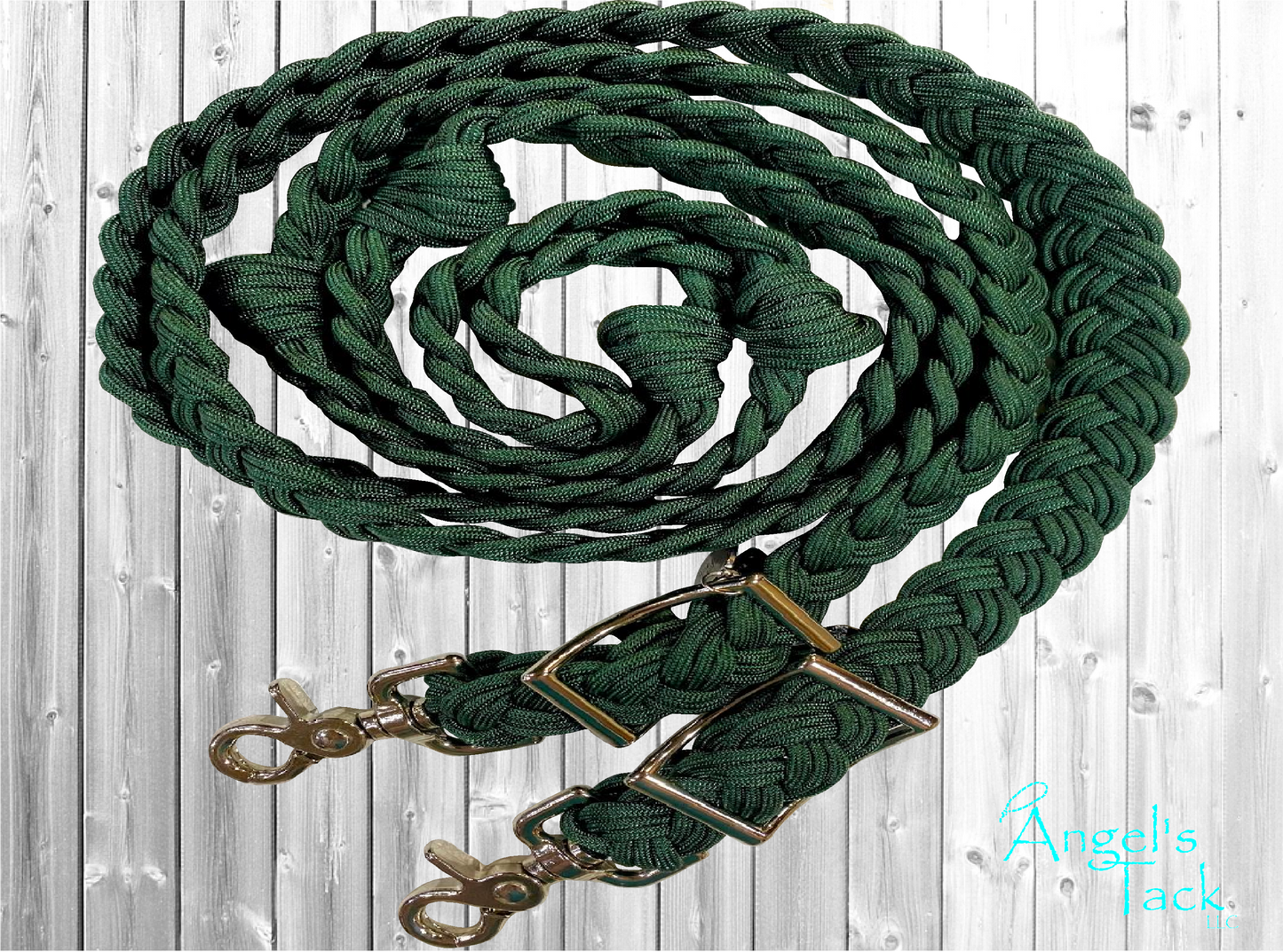Solid hunter green braided paracord barrel reins by Angel's Tack LLC. Shown coiled on a grey wooden background.