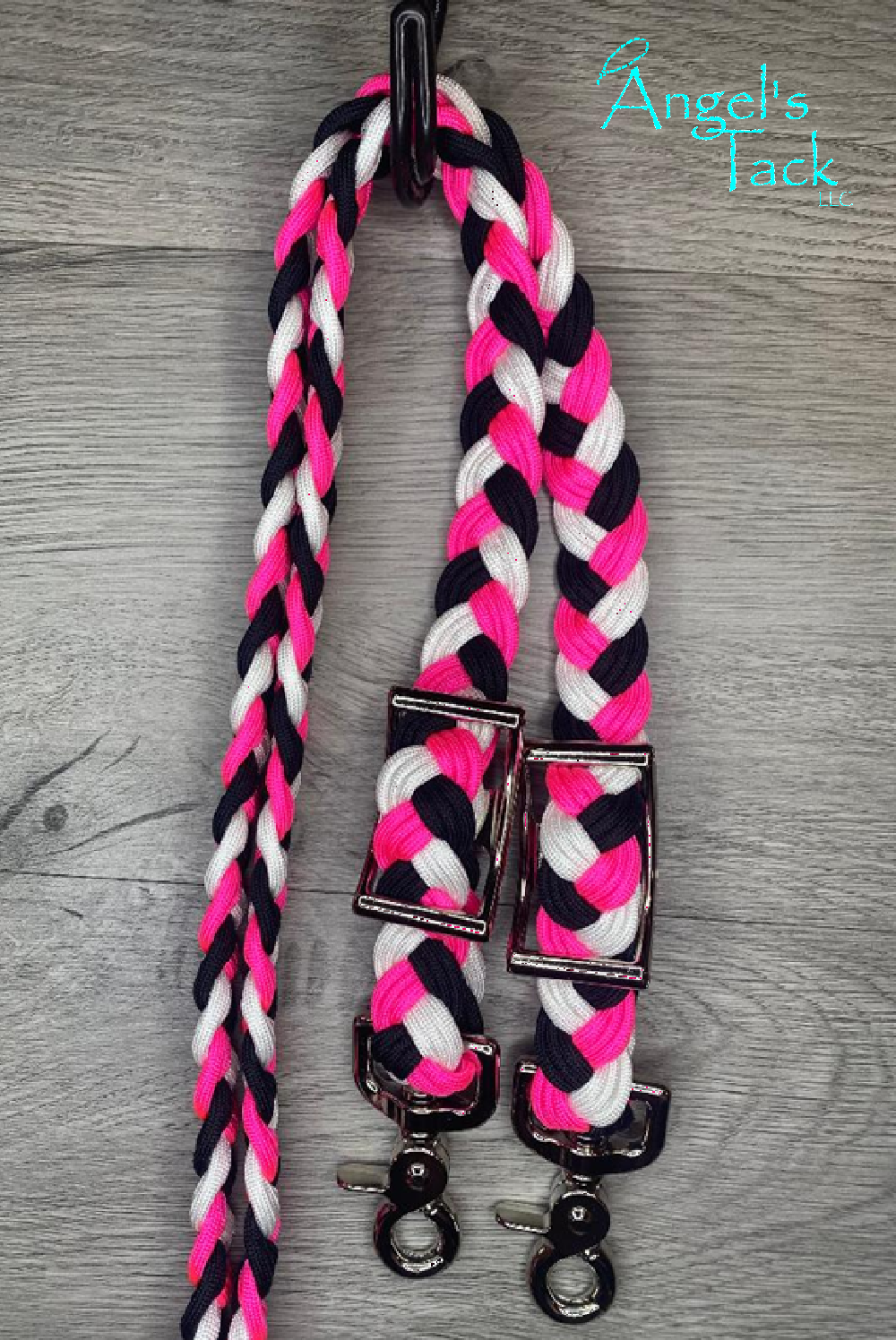Hot pink, black, and white checker barrel reins on a hook