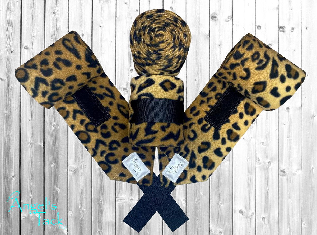 Leopard print horse polo wraps by Angel's Tack LLC. Shown on a grey wooden background.