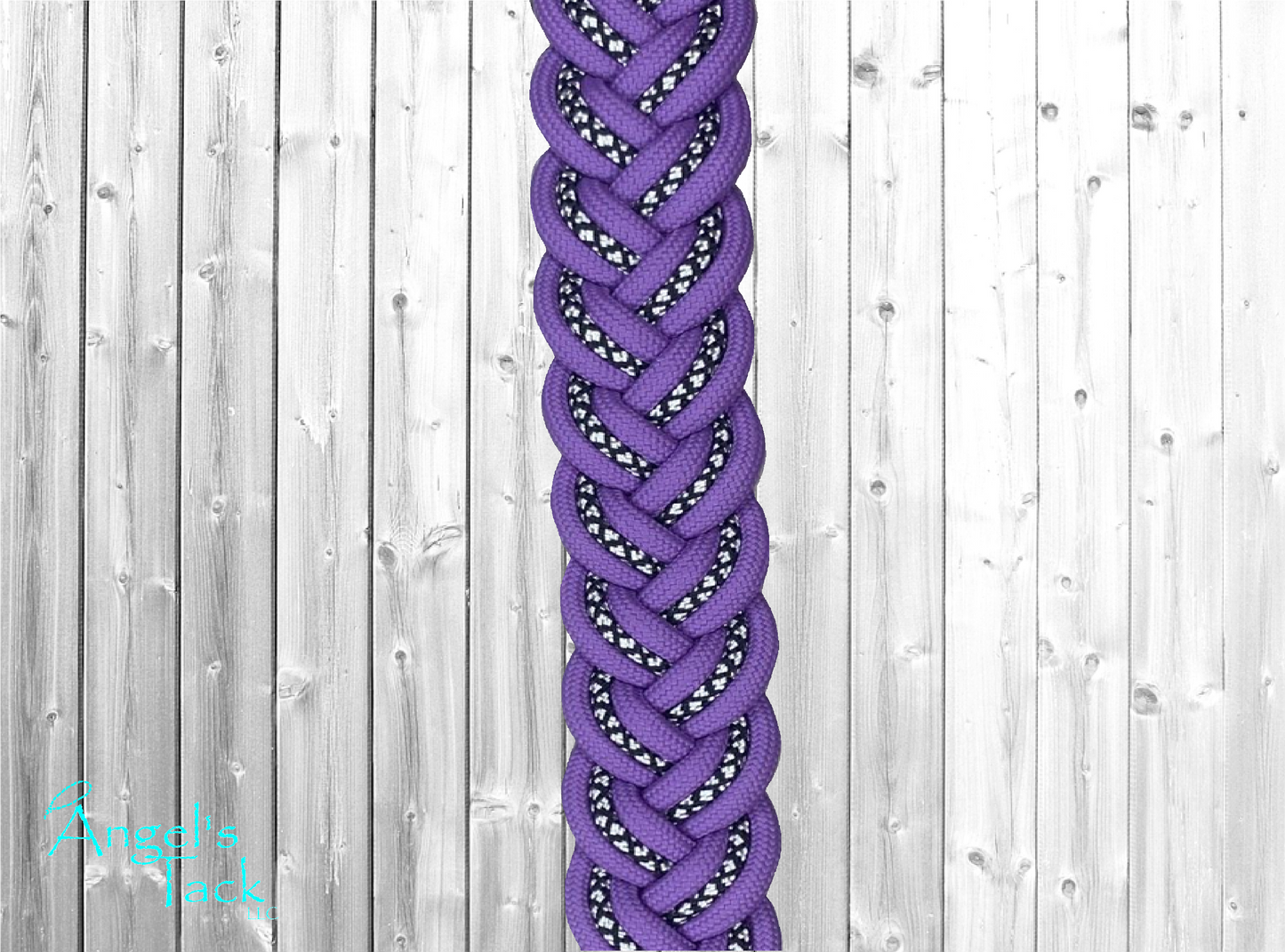 A close up of light purple braided barrel reins with a diamond pattern.