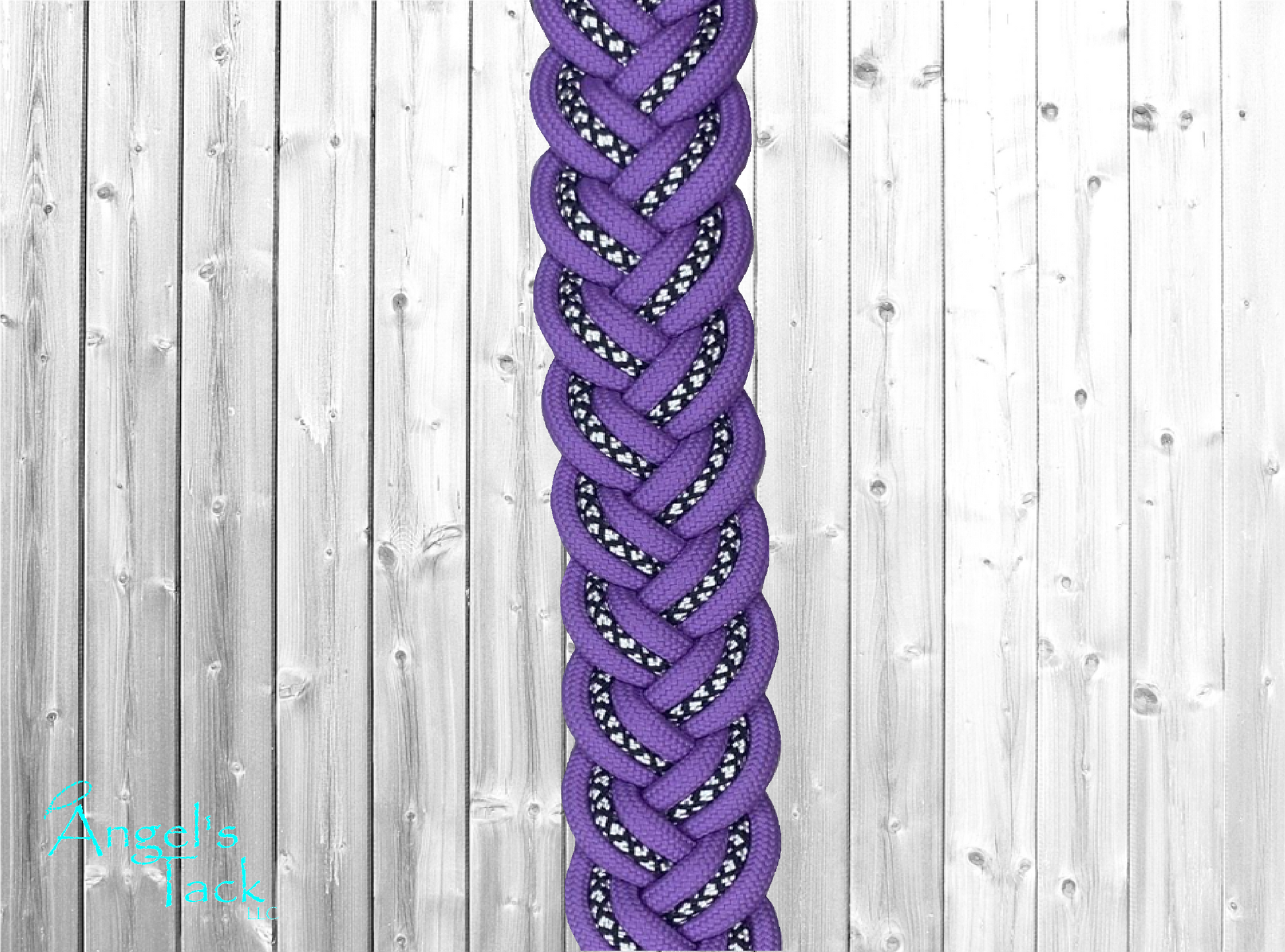 A close up of light purple braided barrel reins with a diamond pattern.