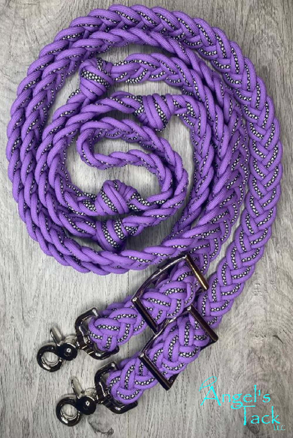 Light purple braided barrel reins with a diamond pattern on a wood background.