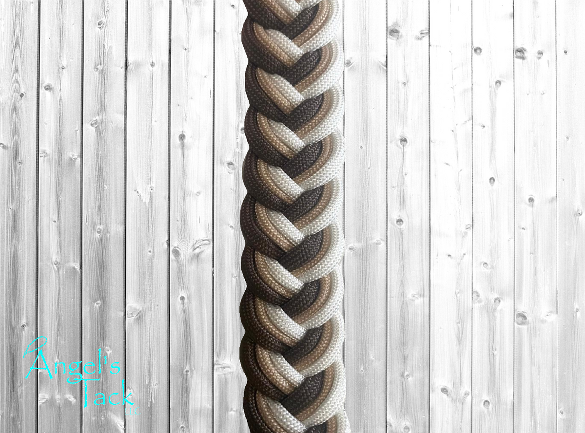 A close up of brown, tan, and white braided paracord barrel reins by Angel's Tack LLC.
