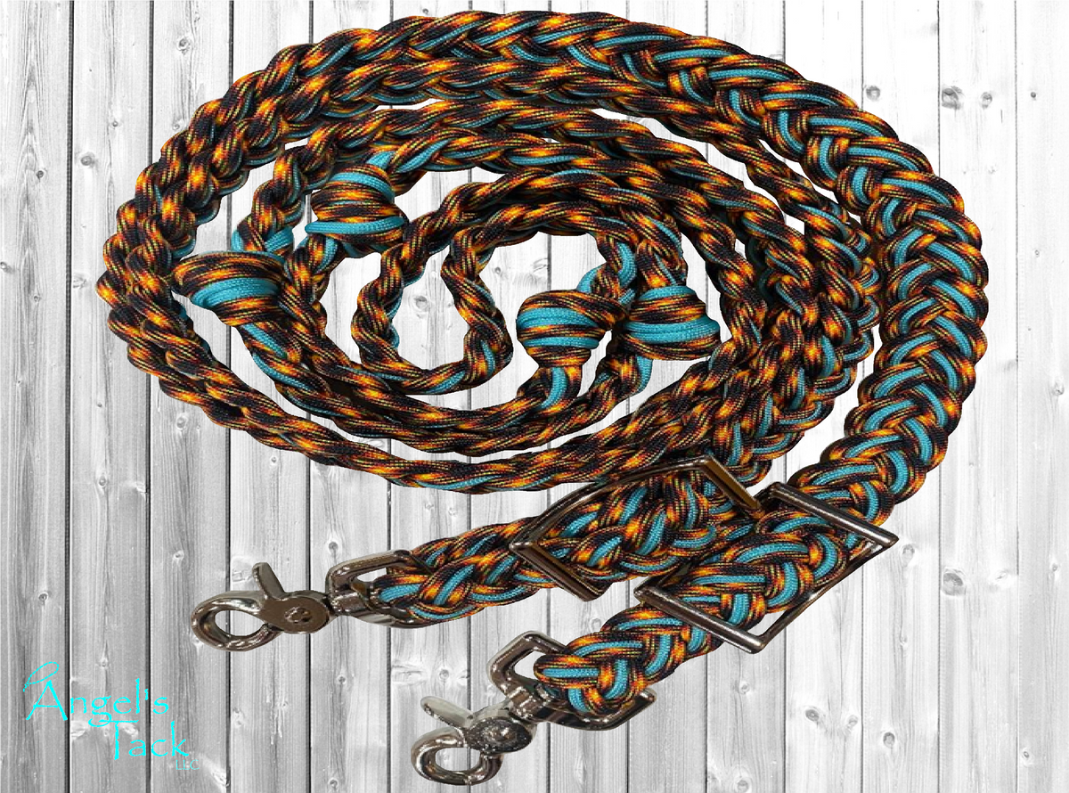 Turquoise and orange flame patterned braided paracord barrel reins by Angel's Tack LLC. Shown coiled on a grey wooden background.